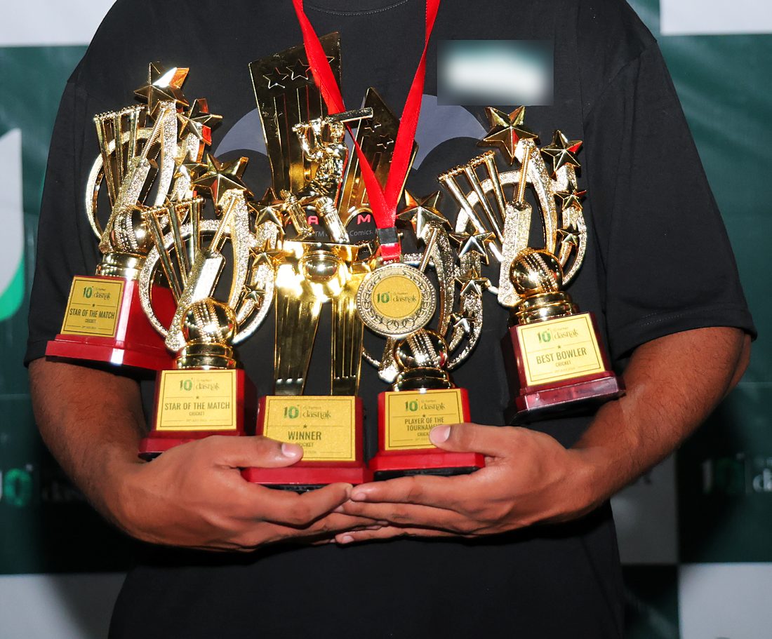 An armful of gold cricket trophies and a medal, each plaque carrying the 10 FarMart dashak lockup: Star of the Match, Winner, Player of the Tournament, Best Bowler.